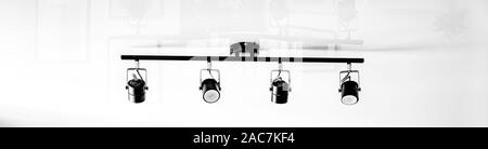 A fragment of the interior of the home loft lighting. Abstract lamp in the form of a soffit in daylight,panoramic image, modern loft style white stret Stock Photo