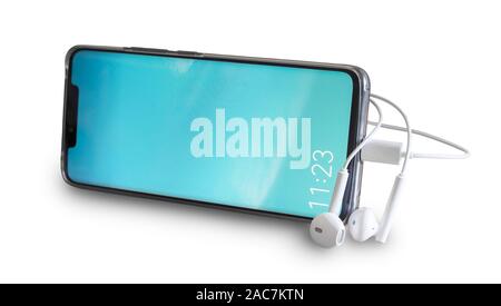 Smartphone and headphones isolated on white background. Stock Photo