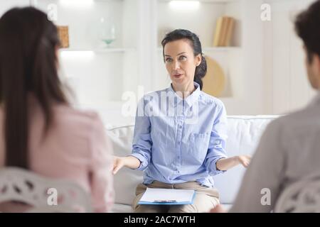Psychotherapist helping couple in her consulting room Stock Photo