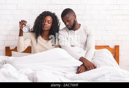 Black married couple having problems with waking up in the morning Stock Photo