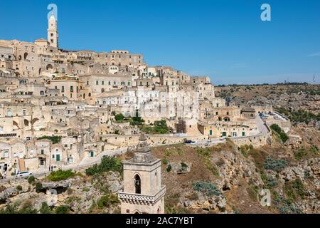 View across Sasso Caveoso to cathedral tower from above Piazza San Pietro Caveoso in Sassi District of Matera, Basilicata Region, Southern Italy Stock Photo