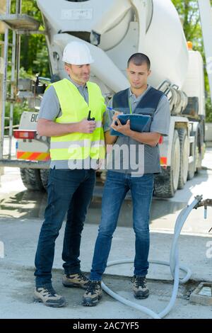 two workers standing on guardrail Stock Photo