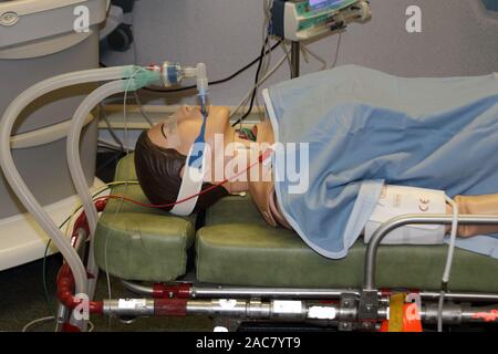 simulated intubated patient on a trolley with equipment in the background Stock Photo