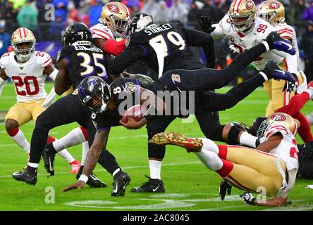 Baltimore, United States. 01st Dec, 2019. Baltimore Ravens quarterback Lamar Jackson (8) dives for a first down against San Francisco 49ers defenders during the first half of an NFL game at M&T Bank Stadium in Baltimore, Maryland, Sunday, December 1, 2019. Photo by David Tulis/UPI Credit: UPI/Alamy Live News Stock Photo