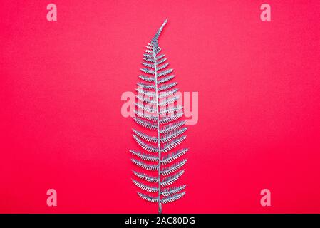 Shining Christmas tree from decoration - silver glitter sparkling on a red background, top view Stock Photo