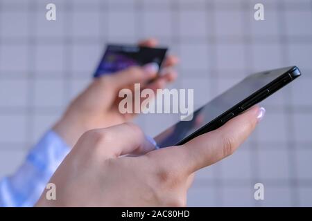 Woman using smartphone and credit card for online shopping Stock Photo