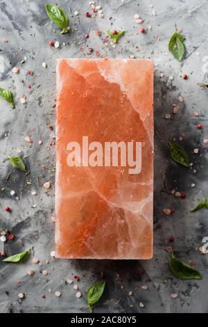 Himalayan pink salt block and spices on gray concrete background top view copy space Stock Photo