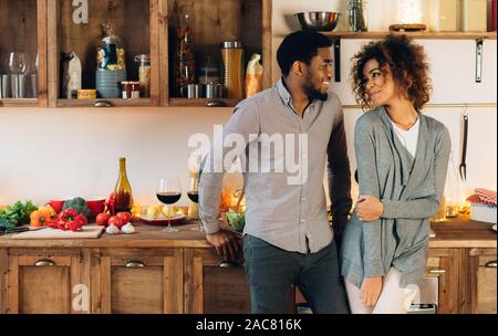 Lovely black couple standing in cozy kitchen Stock Photo