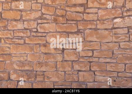 Rough Textured  Brown Exterior Stone Wall Background Stock Photo