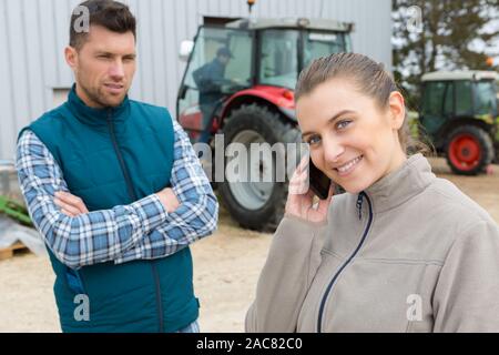 female and male engineer outside a big warehouse Stock Photo