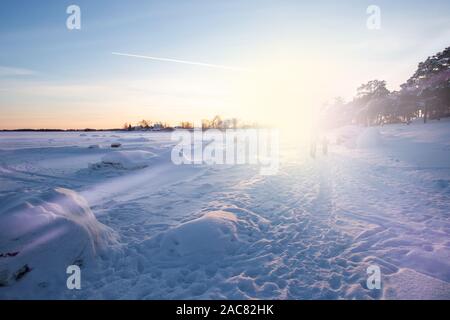 Adult and Child Travelling Along Coast of Frozen Sea Stock Photo