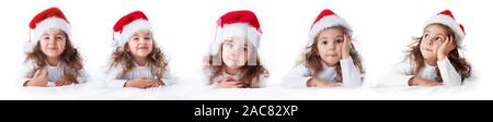 Expressions of little girl in Santa Claus hat smilling.Christmas time. Stock Photo