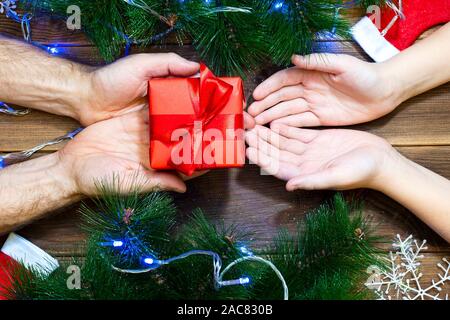 Father gives a Christmas present to his child Stock Photo