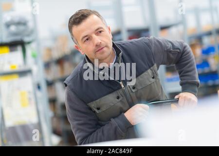 male worker using manual pallet truck Stock Photo