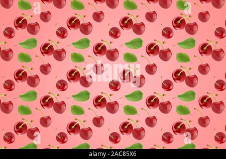 Pattern of cherry fruits with leaves on the pink surface Stock Photo