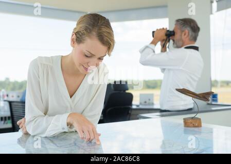 woman on the airport tower studying the map Stock Photo