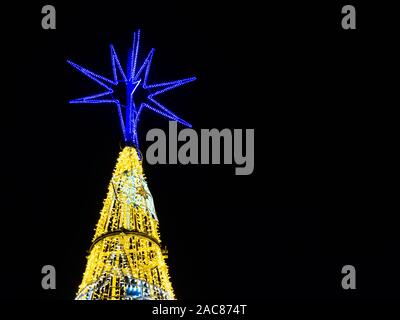 illuminated Christmas tree on black background with space for text Stock Photo