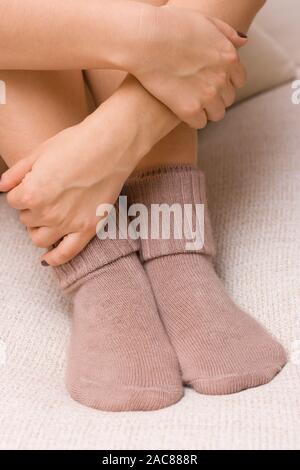 woolen cute socks. Womans feet in wool socks. Stock Photo