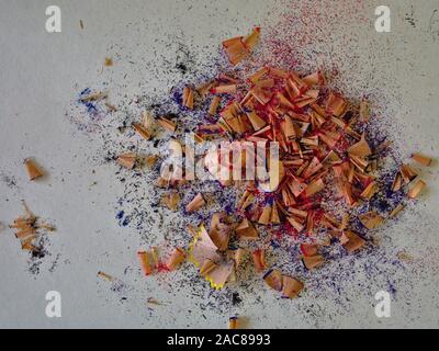 Pile of colouring pencil sharpening wood shavings on a white paper background. Stock Photo
