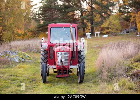 Old red tractor in Skaftholma, Bogesundslandet, Sweden Stock Photo
