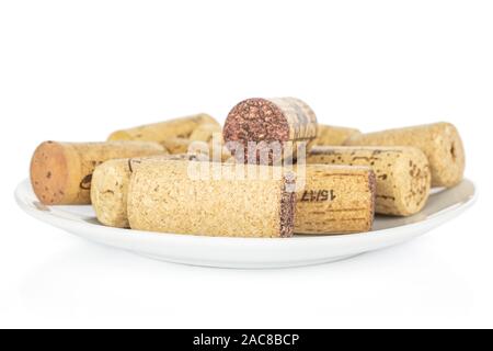 Lot of whole common wine cork on white ceramic plate isolated on white background Stock Photo