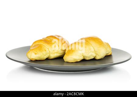 Group of two whole sweet golden mini croissant on gray ceramic plate isolated on white background Stock Photo