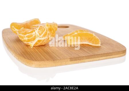 Group of one half three pieces of fresh orange mandarin on bamboo cutting board isolated on white background Stock Photo