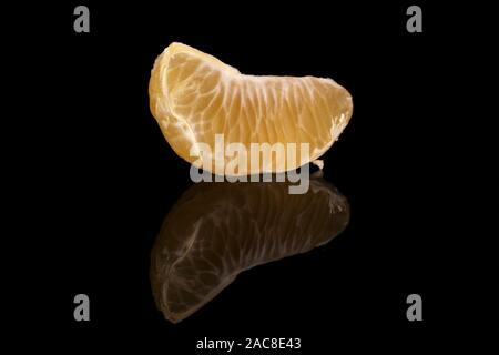 One piece of purified fresh orange mandarin segment isolated on black glass Stock Photo