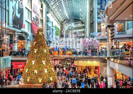 Toronto, Canada - December 12, 2011:  Customers shop at the busy Eaton Centre which is decorated for Christmas. Stock Photo