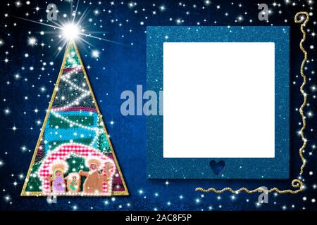 Christmas empty picture frame greetings cards. Nativiy Scene, Christmas tree and blue glitter empty picture frame hanging on blue background. Stock Photo