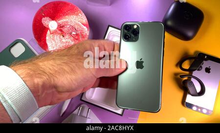 Paris, France - Sep 20, 2019: Admiring the rear triple camera Man hand unboxing unpacking new latest Apple Computers iPhone 11 Pro and 11 Pro Max smartphone triple-lens camera and new technology CPU Stock Photo