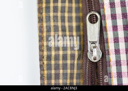 Metallic zipper for clothes / Close up open zip on handbag Stock Photo