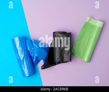 rolled up rolls with plastic garbage bags on a blue background Stock Photo