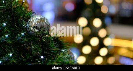 Decorated Christmas tree light on blurred background on holiday merry christmas background tree branch on postcard Stock Photo