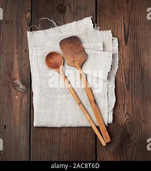 wooden old spoon and spatula on a gray linen napkin, top view Stock Photo