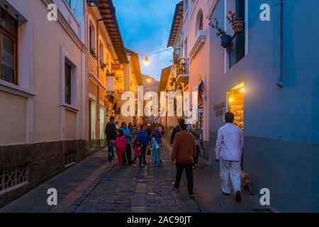 Visitors to Calle La Ronda in Oldtown Quito enjoying themselves on a warm evening. Calle La Ronda is home to numerous artisans and shops. Stock Photo