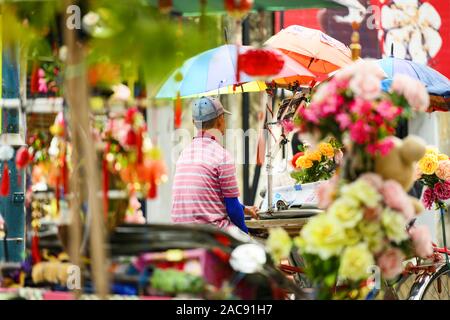 (Selective focus) A unidentified trishaw driver is waiting for customers in Armenian Street, George Town Penang State, Malaysia. Stock Photo