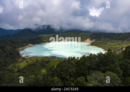 View from above, stunning aerial view of the Talaga Bodas Lake surrounded by a green tropical forest. Stock Photo