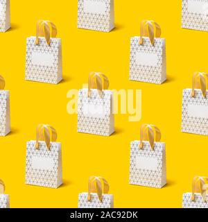 Seamless texture with White shopping bag on yellow background. Holiday sale concept, isometric view. Stock Photo