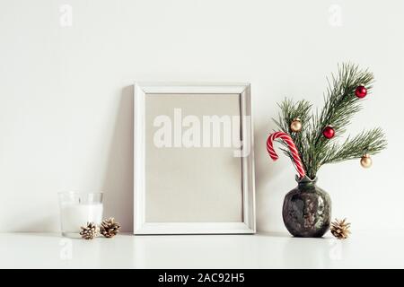 White Composition with little Christmas tree in vase and candles. Copy space for lettering. Stock Photo