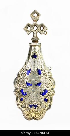 Antique Eighteenth century French silver gilt blue glass perfume or holy water bottle  an ornate bright cut floral pattern and stopper on white Stock Photo