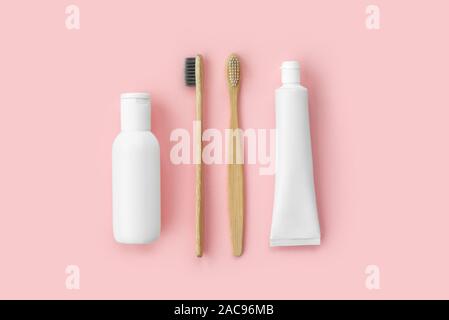 Set of eco-friendly toothbrushes, toothpaste and other tools on pink background. Dental and healthcare concept. Top view, flat lay. Stock Photo