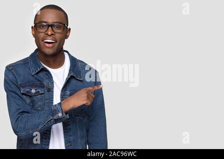 Happy African American man pointing finger at copy space Stock Photo