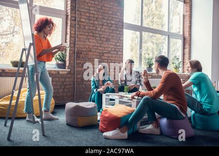 Holding construction model. Close up of future architect holding construction model while working on group project Stock Photo