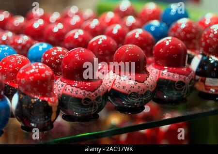 Russian plump red and blue dolls turned back on a beautifully blurred background Stock Photo