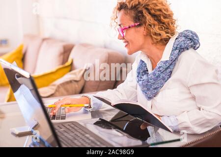 Business independent young woman work at home for digital freedom modern concept - technology and computer for caucasian people working on the table d Stock Photo