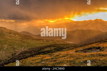A stunningly brilliant golden hour display during a thunderstorm from the Gore Range Overlook on Trail Ridge Road, Rocky Mountain National Park, Color Stock Photo