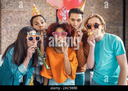 Nice birthday party. Cheerful students enjoying their time while having nice birthday party Stock Photo