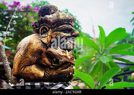 Traditional Balinese Bedogol Dwarapala decorated for festival by ceremonial offering. Protective guardian in front of doors, gates of hindu temples Stock Photo