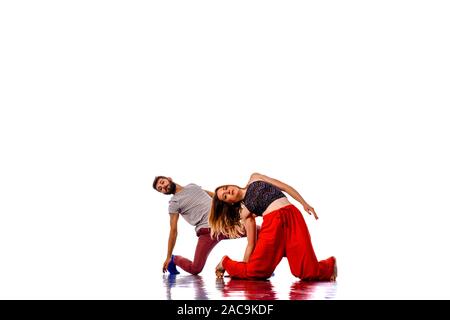 Teenagers skill and talent of modern dance, dancing in studio over white background Stock Photo